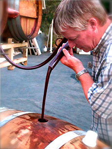 Andrew Tanis making Barbera wine.  Very deep, dark colored wine.