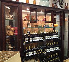 New Tasting Room showing wine bottles and special antiques.
